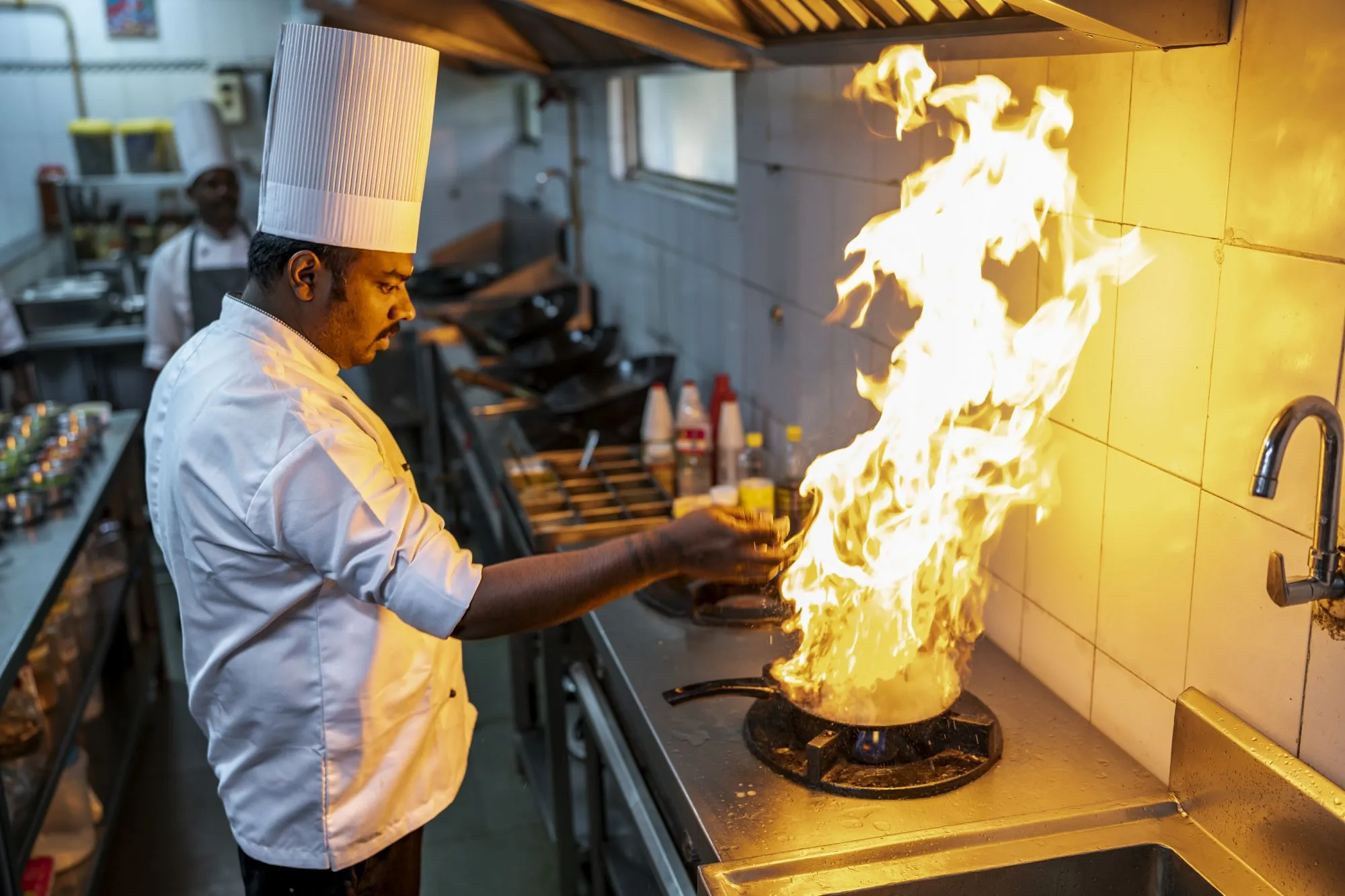 Chef preparing a dish at Top Station Multi Cuisine Restaurant